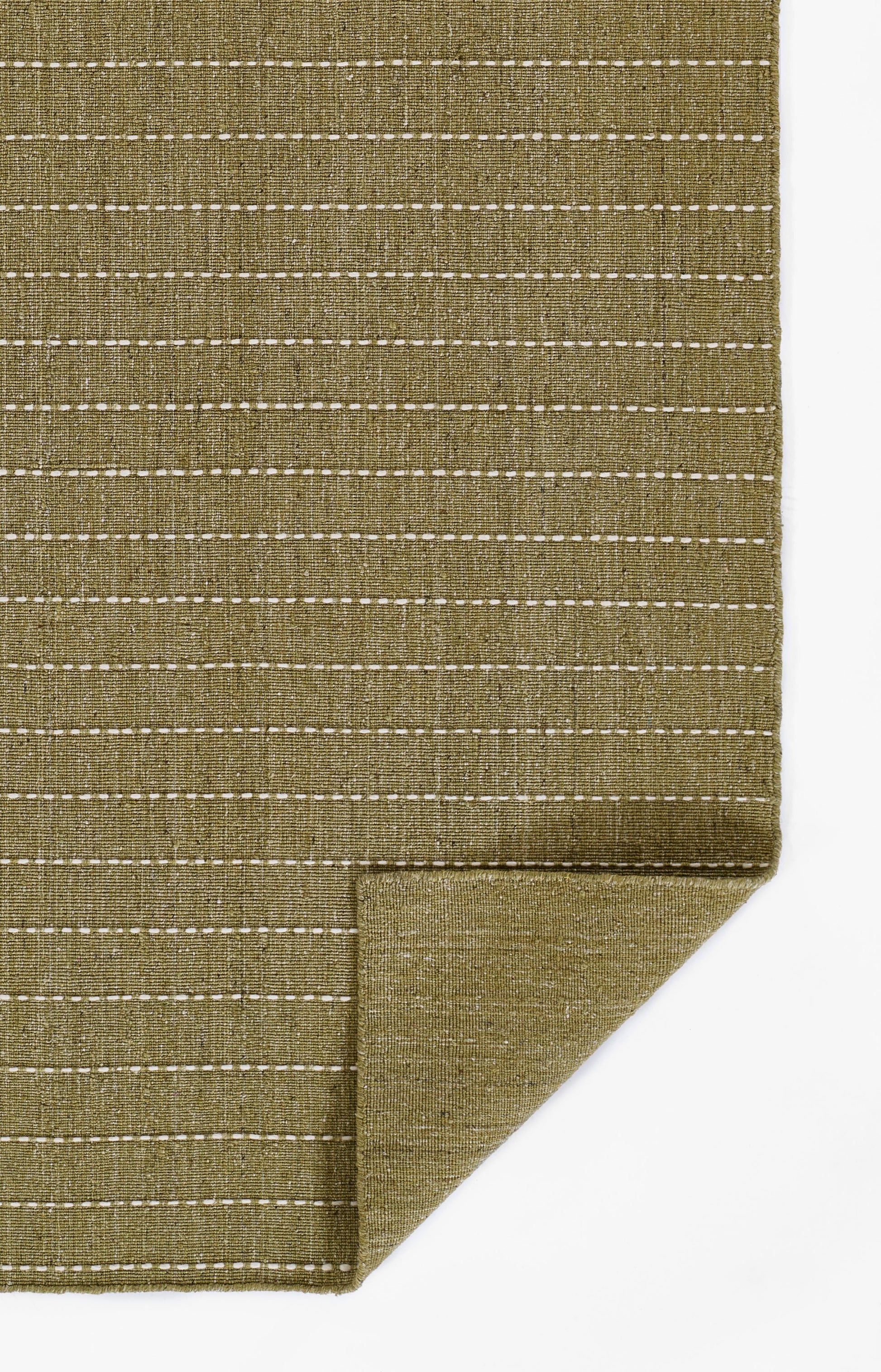 Olive green woven rug with white dashed stripes and a folded corner.
