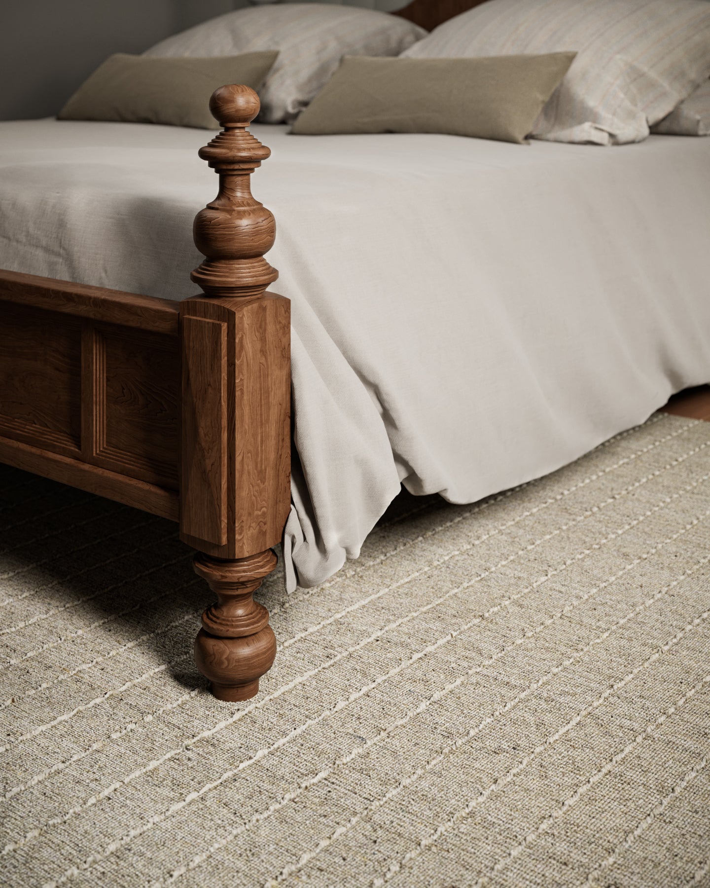Olive and natural area rug on the floor with beige bedding visible.