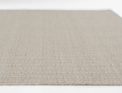 Beige natural jute rug with a subtle grid weave, rustic farmhouse decor.