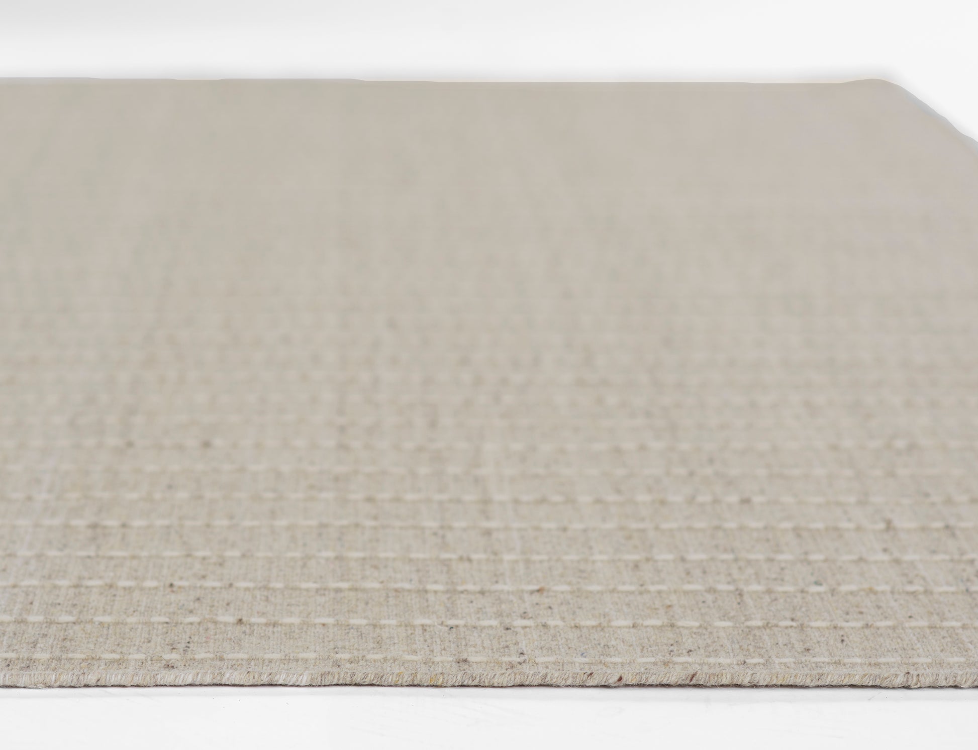 Natural beige woven rug with a subtle grid texture, 9' x 12'.