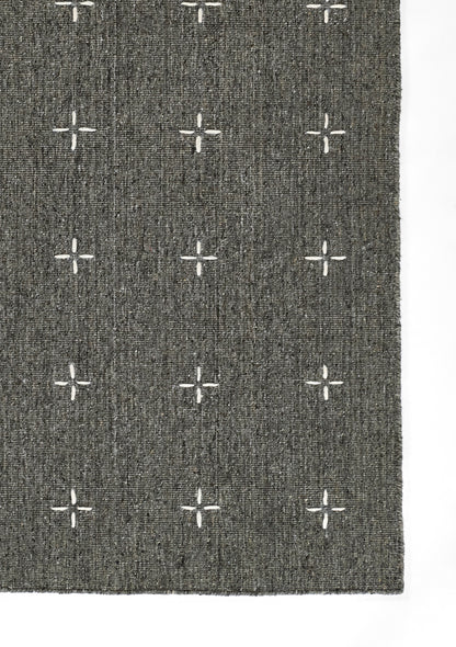 Rectangular charcoal gray woven rug with white cross motifs in a grid; modern geometric style, for living room or hallway.