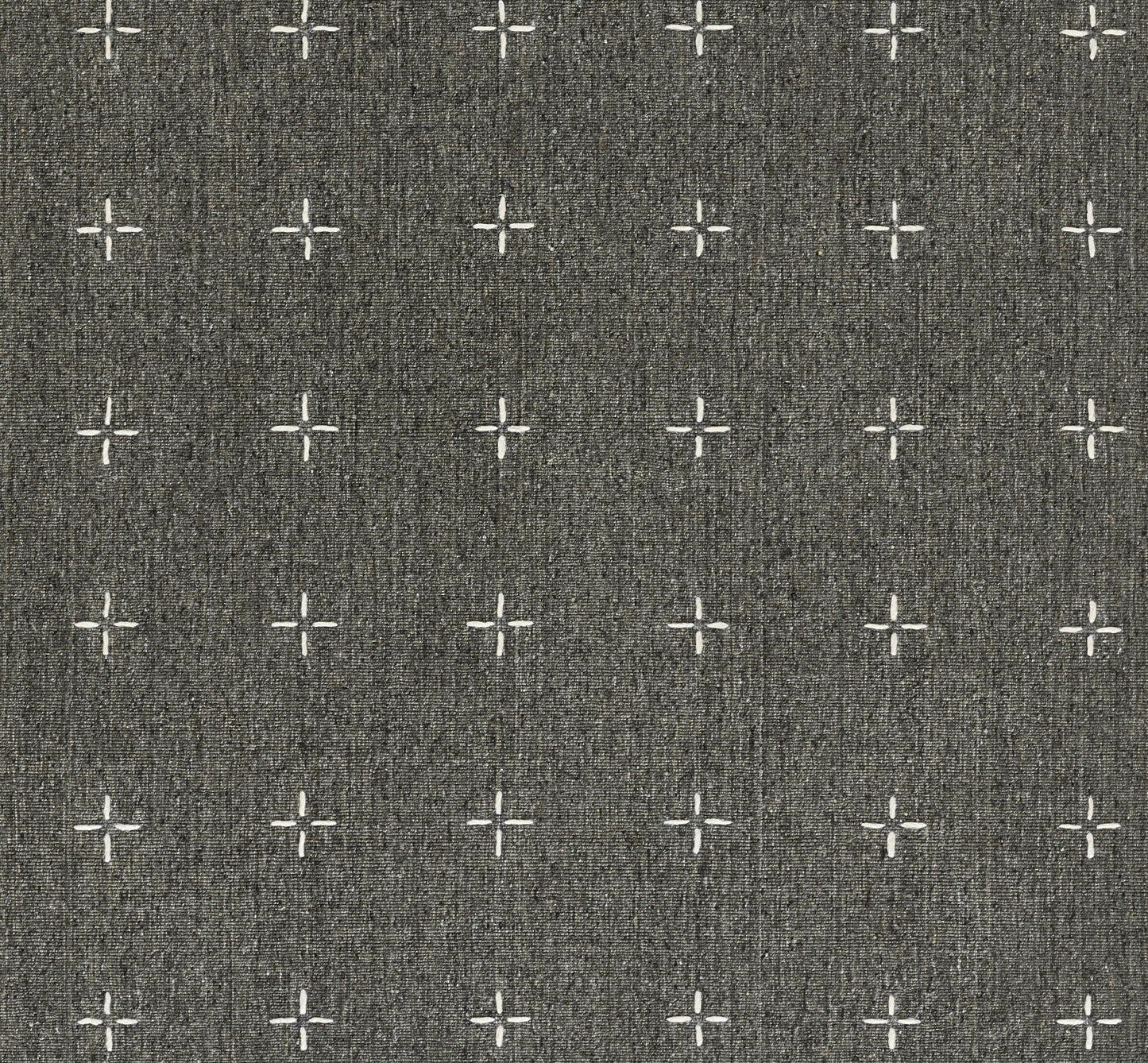 Charcoal gray woven rug with repeating white cross and plus motifs.