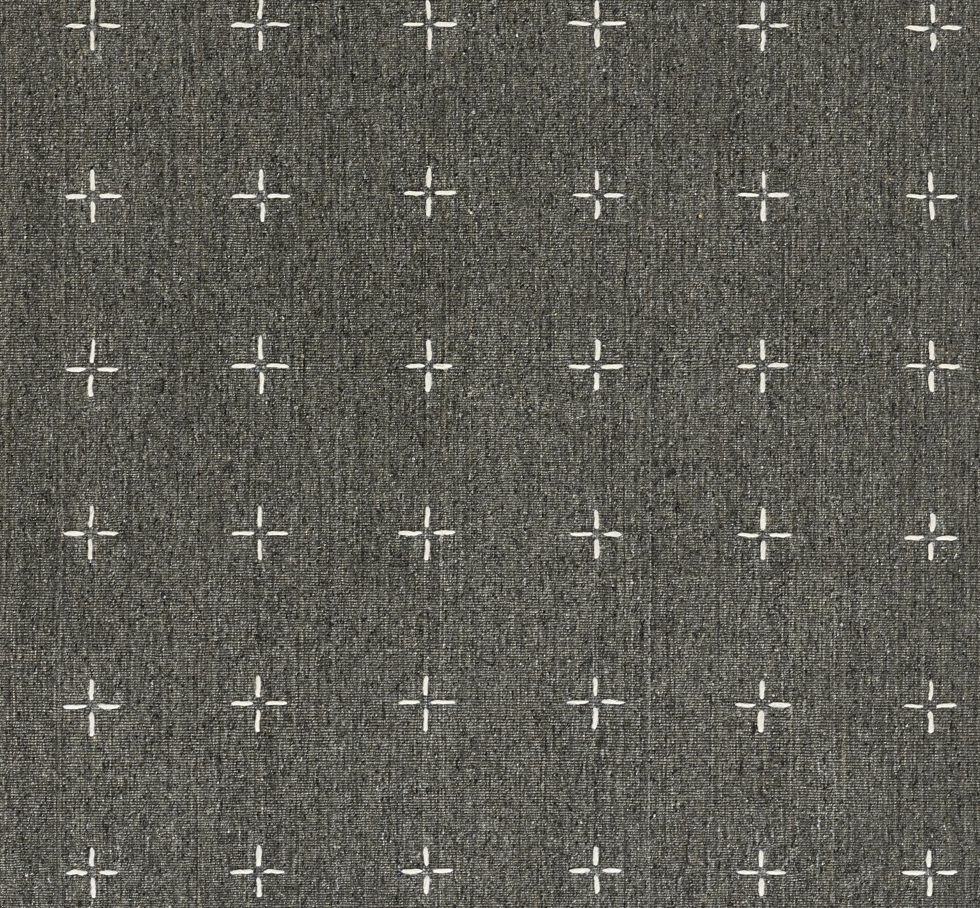 Charcoal gray woven rug with repeating white cross and plus motifs.