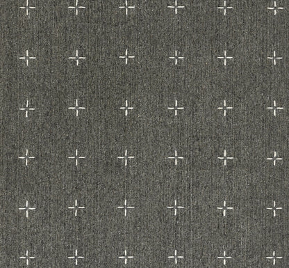 Charcoal gray woven rug with repeating white cross and plus motifs.
