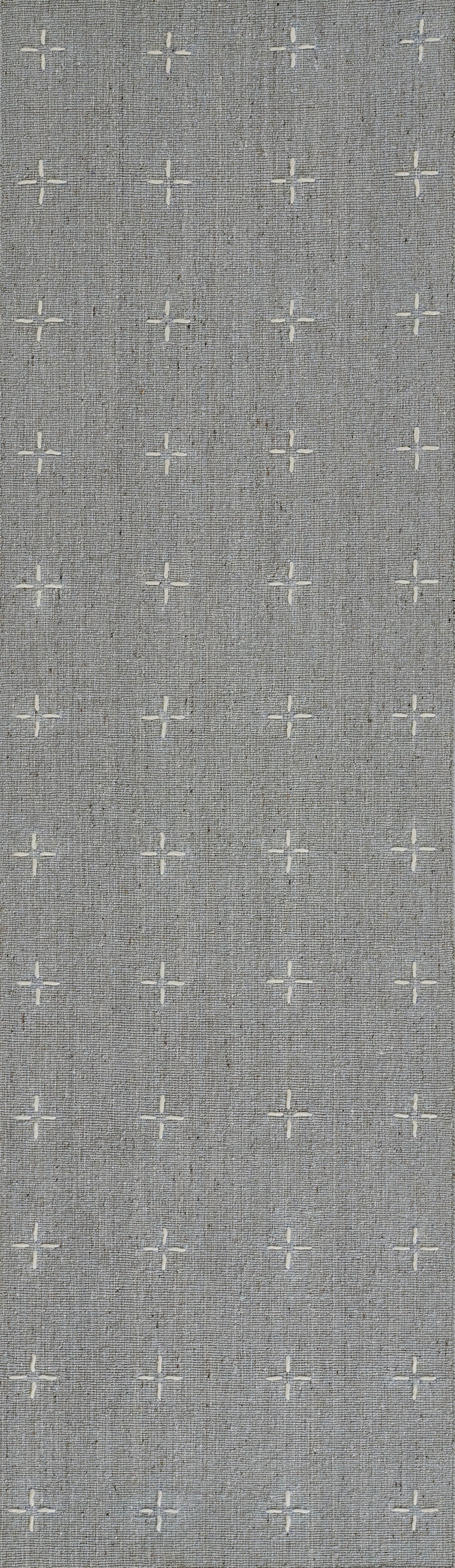 Grey woven fabric rug with subtle texture and white cross-stitch plus motifs arranged in a grid.
