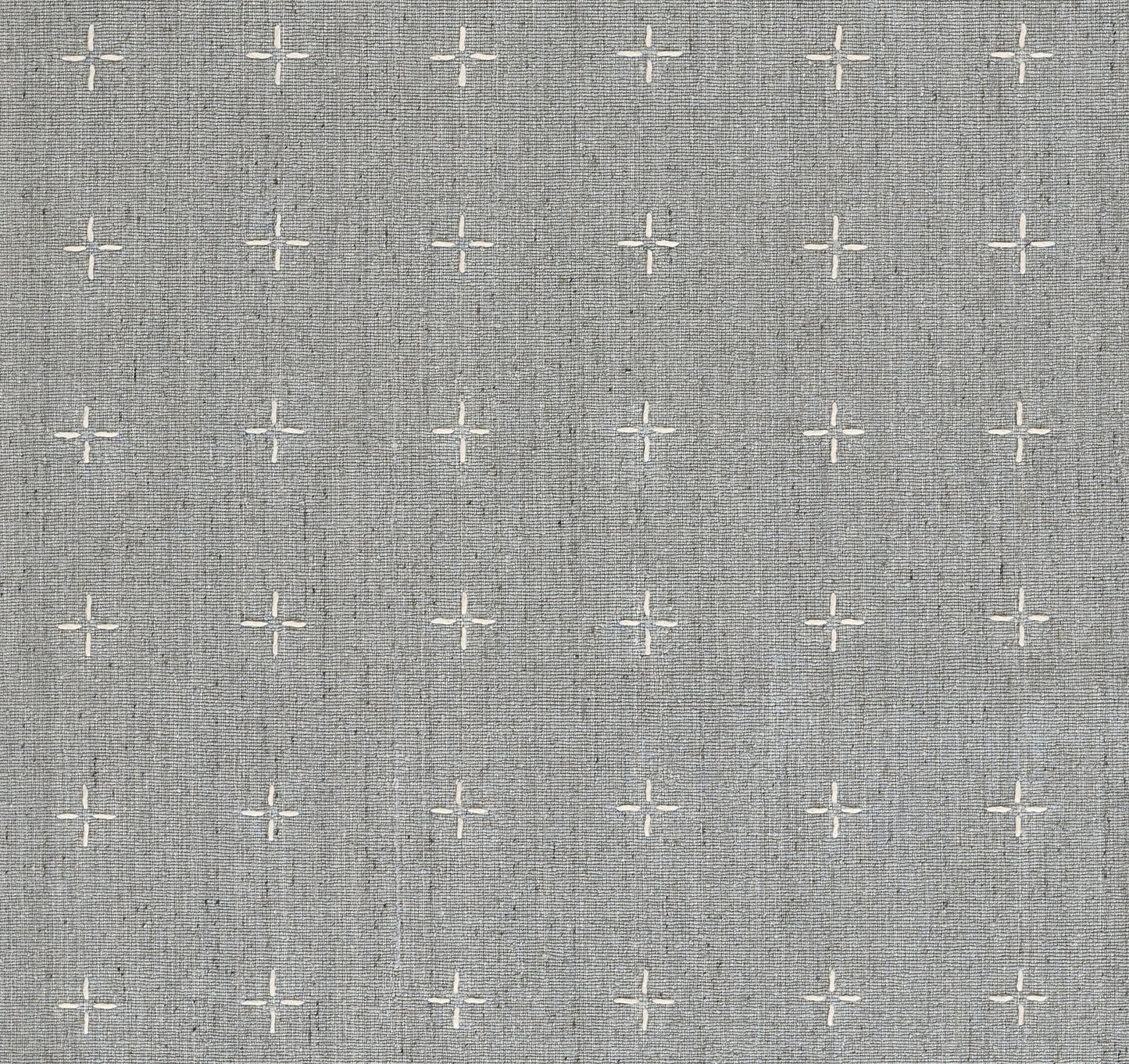 Gray linen-textured rug with evenly spaced white cross-stitch motifs.