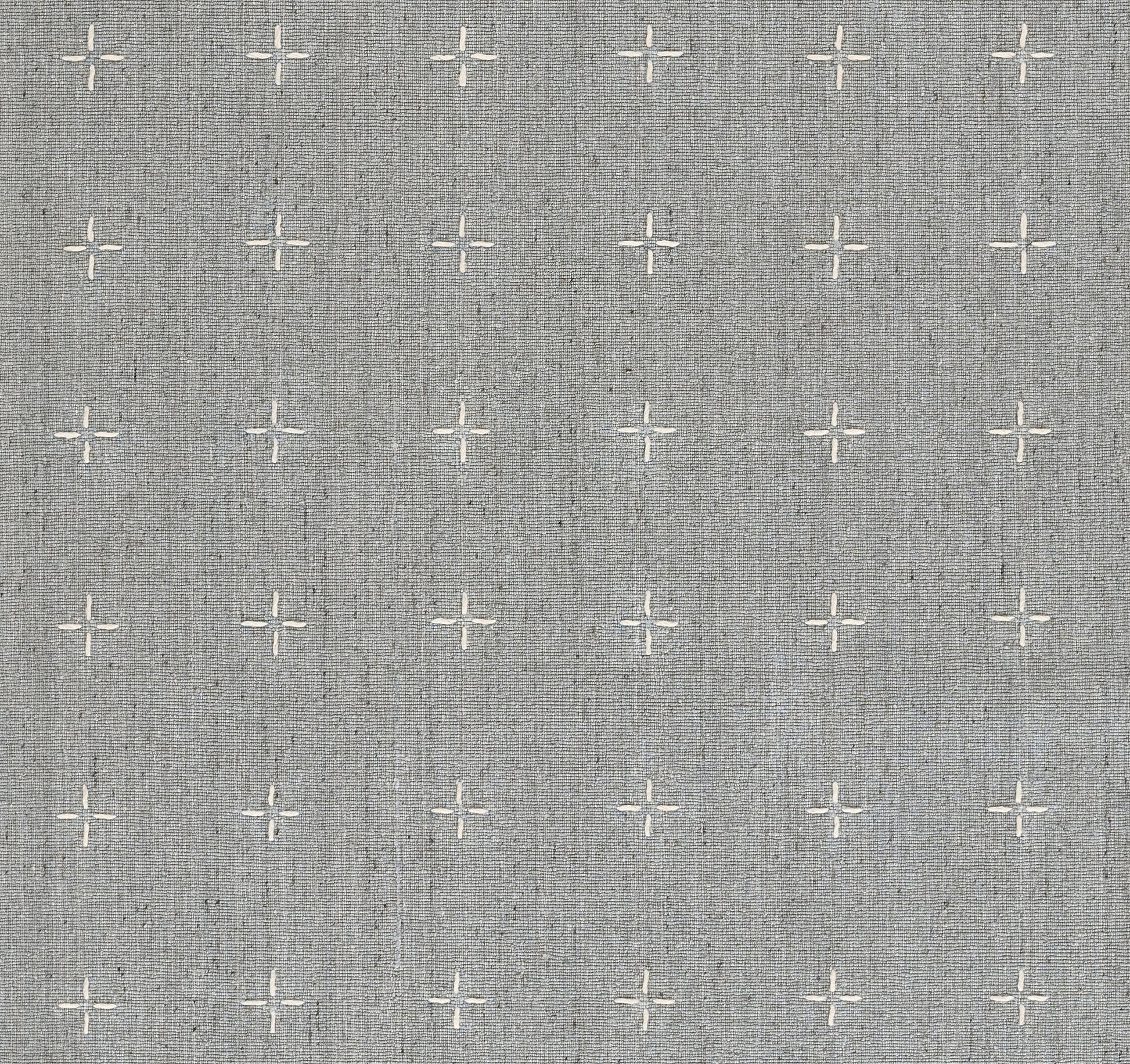 Grey linen-textured rug with a subtle geometric pattern formed by white cross-stitch detailing.
