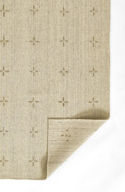 Beige woven rug with small plus-shaped cross motifs; textured natural fibers and folded corner.