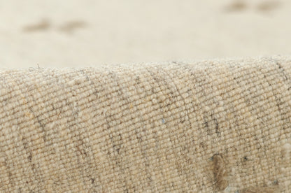 Olive-toned natural-fiber rug close-up, tightly woven boucle texture with subtle flecks for a rustic, cozy look