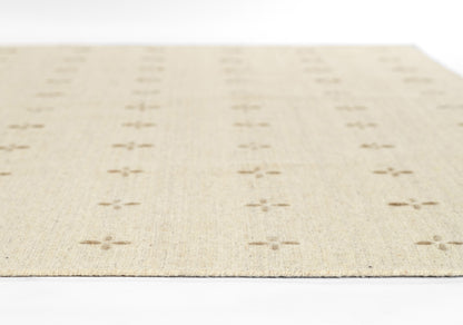 Beige woven rug with repeating cross-dot motifs in rows; natural fiber flat weave, rectangular, modern casual decor.