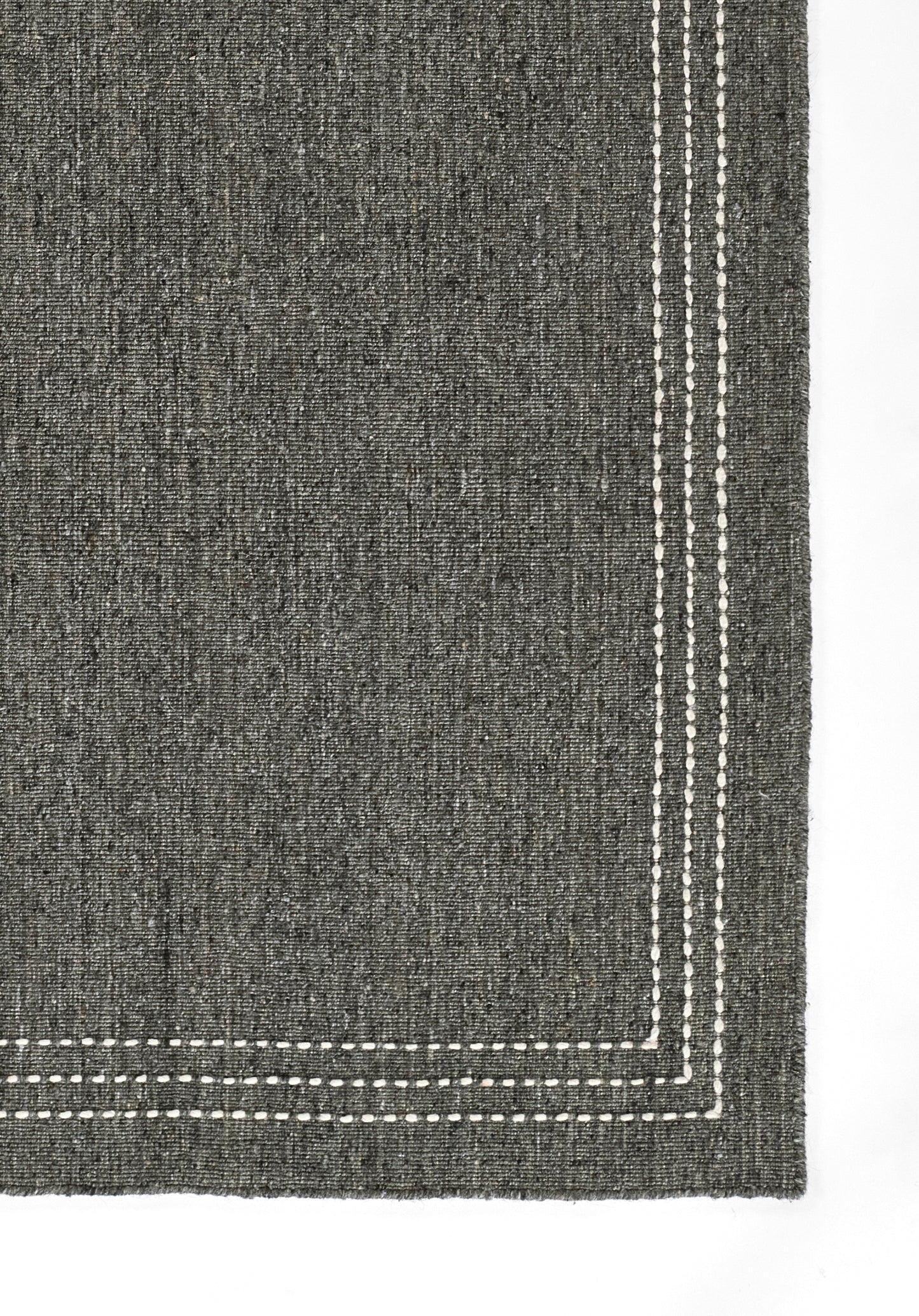 Charcoal grey woven rug (9' x 12') with a white double-stitch border along the edges.