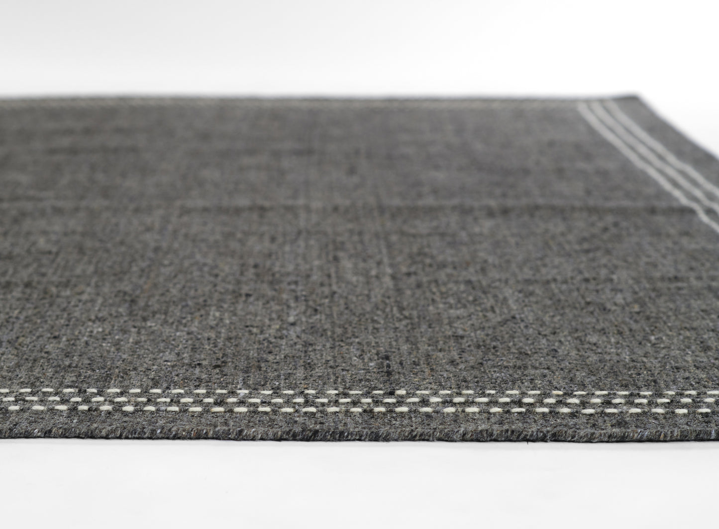 Olive flatwoven rug with white stitched border and subtle texture, rectangular, modern home decor.