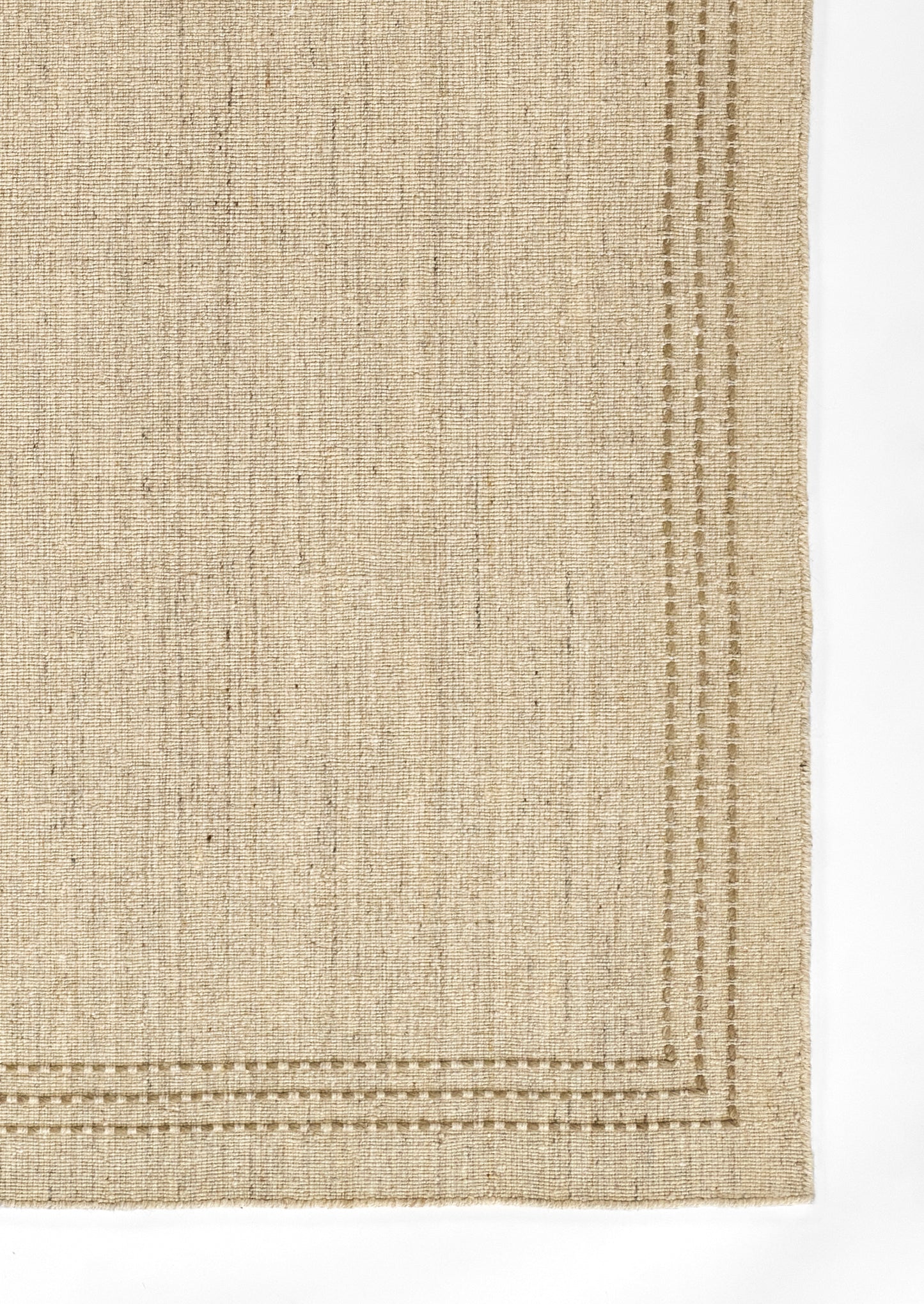 Beige natural jute rug with woven texture and double-stitched border along edges.