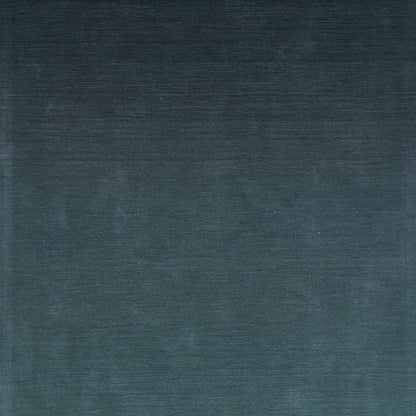 Dark blue ombre velvet rug with subtle brushed grain; plush.