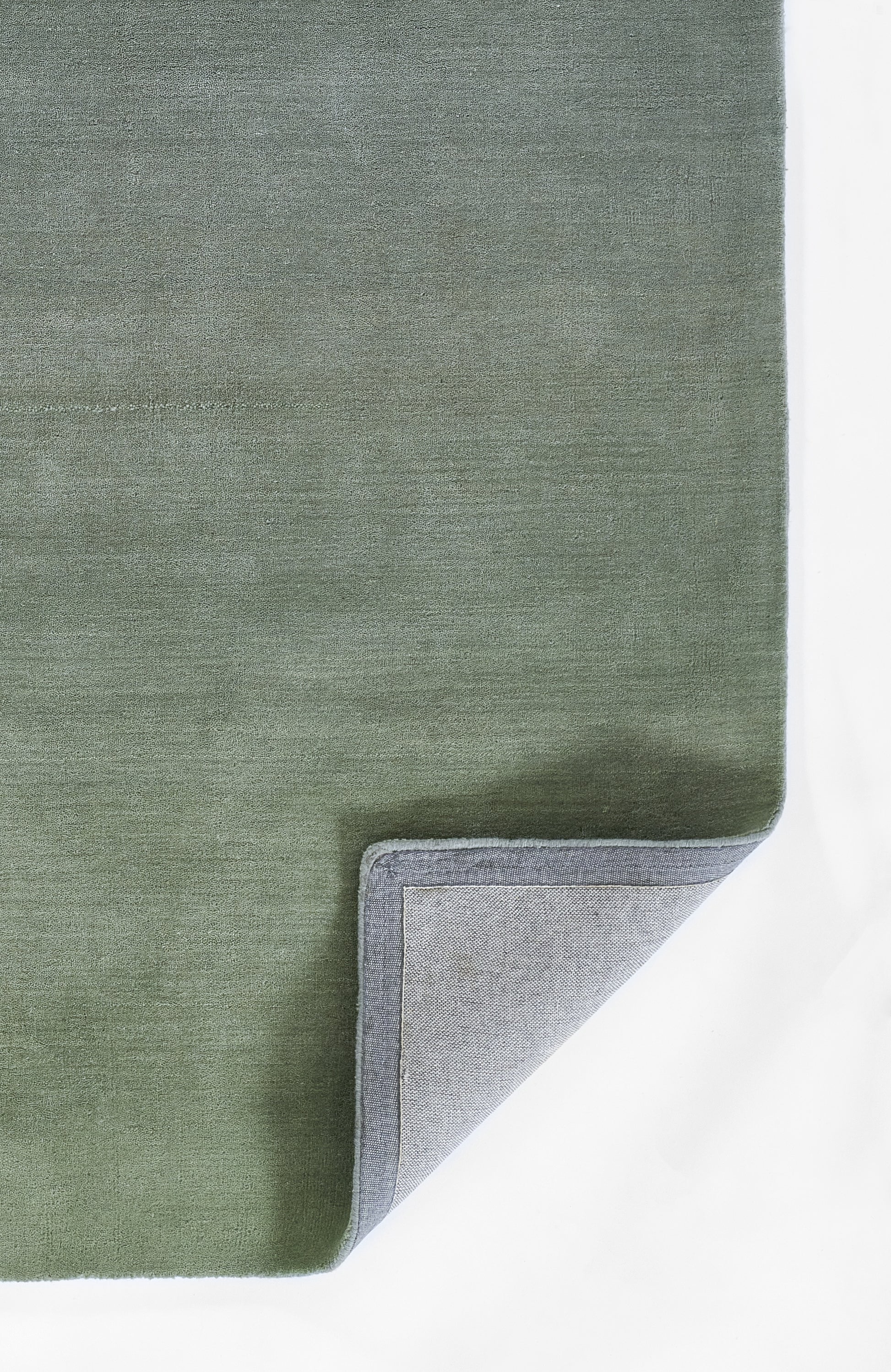 Olive green ombre rug with velvet pile & gray binding edge, folded to reveal light gray underside.