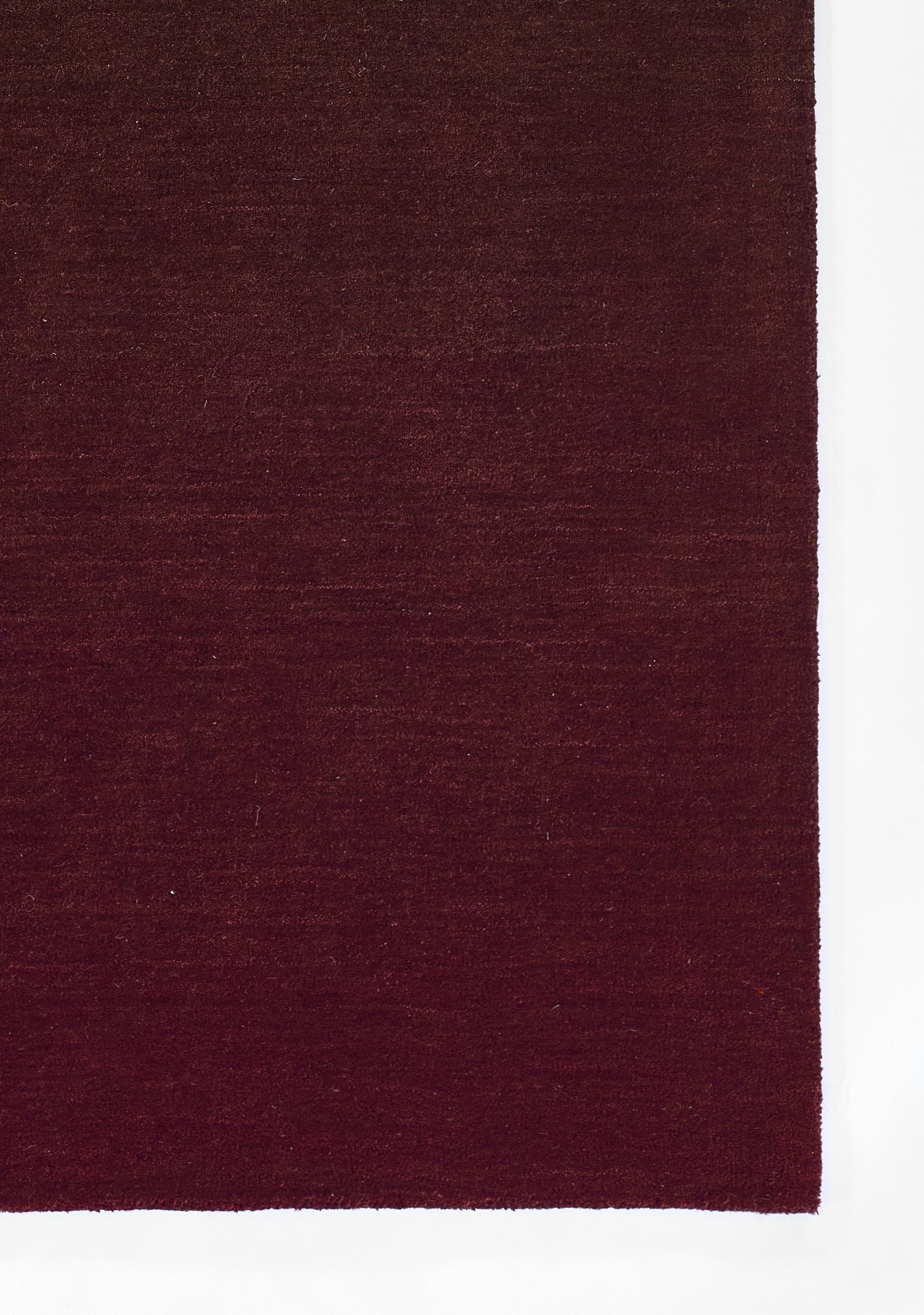 Deep burgundy rectangular rug with plush pile and rich wine-red color.