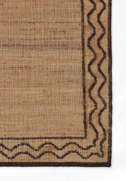 Natural tan jute rug with dark brown zigzag border; rectangular, rustic woven style.