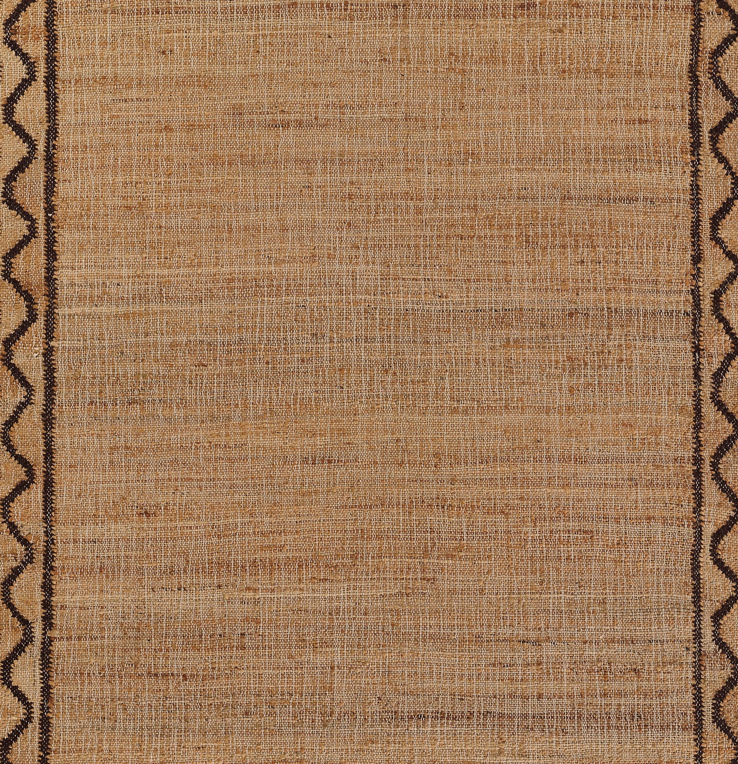 Brown woven rug in tan tones with dark brown scalloped borders along edges; rustic tribal style.
