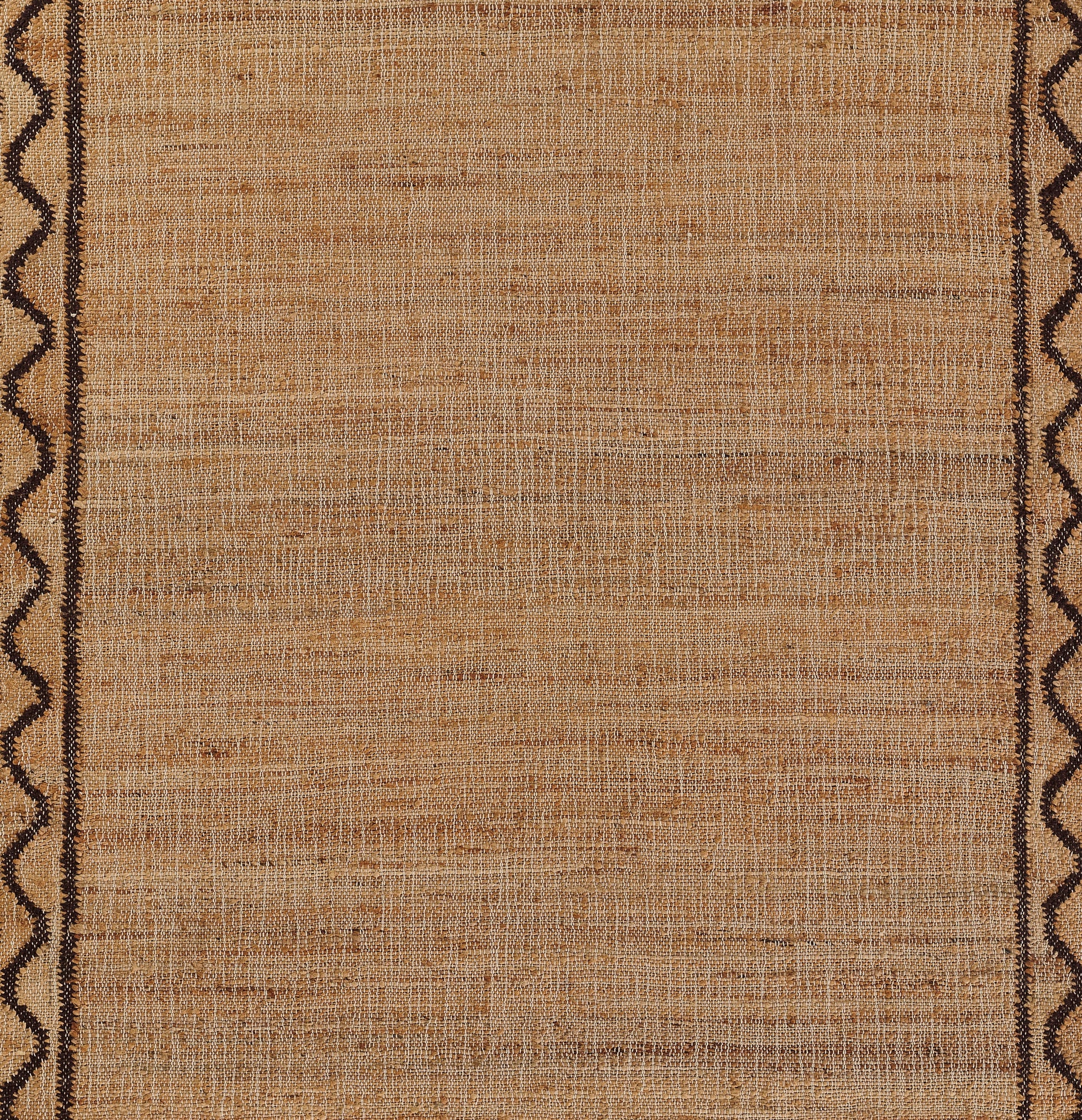 Natural tan jute rug with a dark brown scalloped border along the vertical edges.