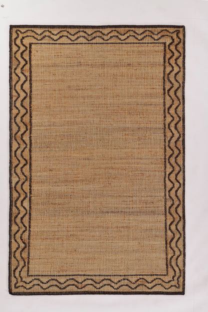 Natural beige jute rug with dark brown wavy border and double inner bands; rectangular woven mat.