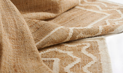 Natural beige jute rug with cream geometric border; textured woven pile for boho-style floor decor.