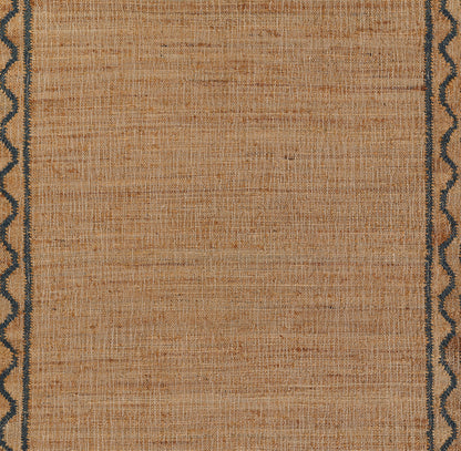 Beige woven rug with navy blue wavy border along edges; rectangular, rustic natural-fiber style.