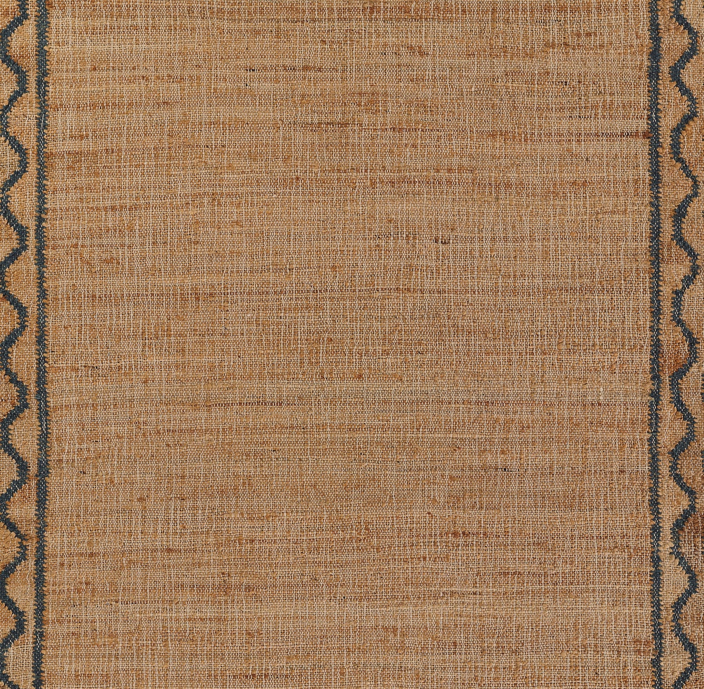 Beige flat-weave rug with dark blue scalloped border along the sides; warm textured central field.