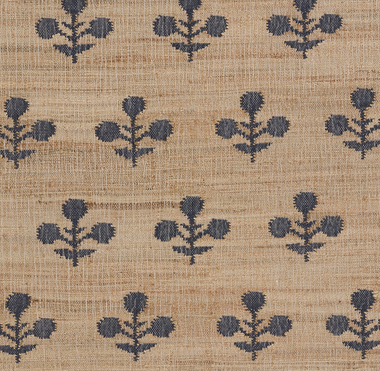 Beige woven rug runner with navy blue botanical floral motifs in a repeating pattern; rustic linen look.