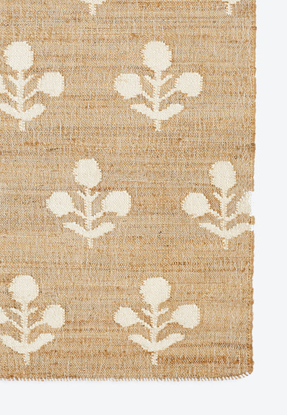 Natural beige jute rug with white floral botanical pattern and short fringe edges