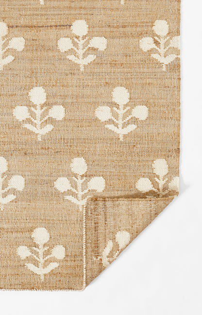Natural beige jute runner rug with a white botanical floral pattern, woven texture, folded corner, 2'3" x 8'.