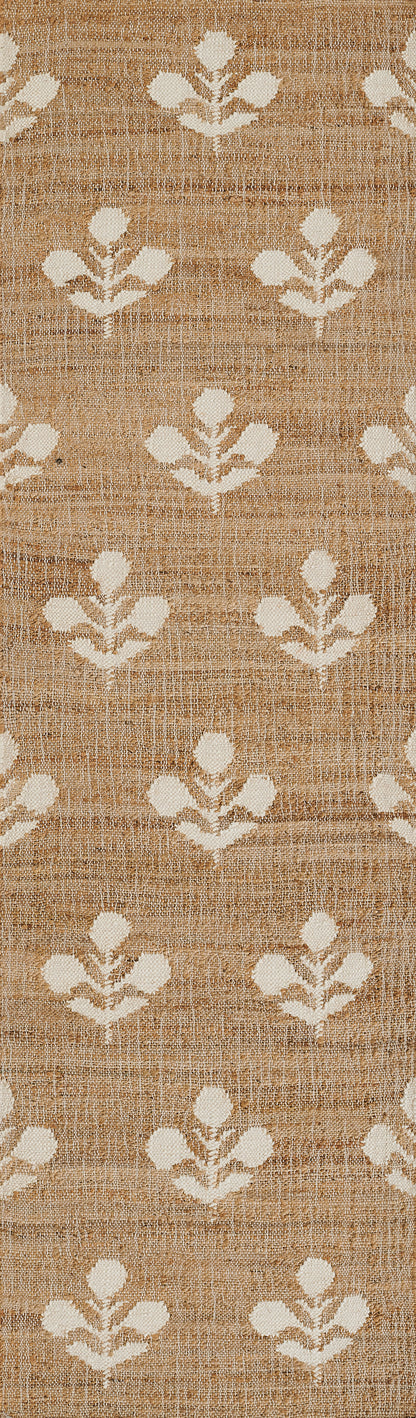 Beige jute rug with white leaf-like motifs in a repeating geometric pattern; natural textured weave.