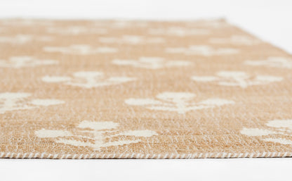 Natural beige jute rug with white cross motifs; flat-weave, textured surface, neutral coastal style.