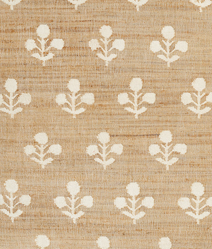 Beige rug with a linen-textured surface and repeating ivory floral motifs in a simple farmhouse pattern, 2' x 3'.