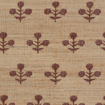 Beige rug with repeating dark brown botanical motifs; burlap-like texture giving a rustic, natural floor covering.