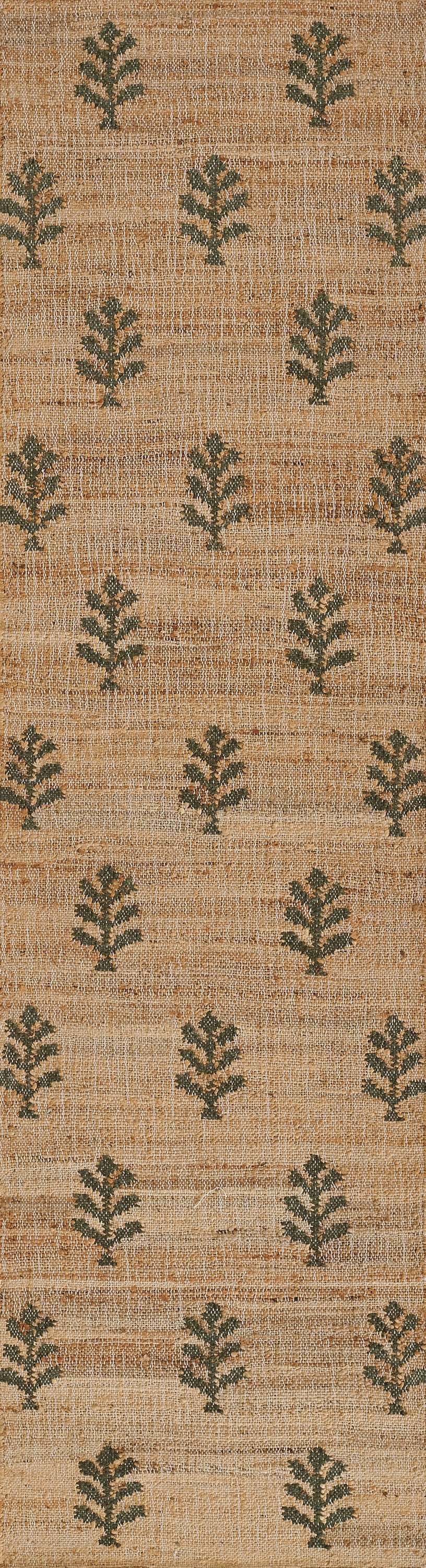 Natural beige jute rug with repeating dark green botanical leaf motifs in a woven rustic style.