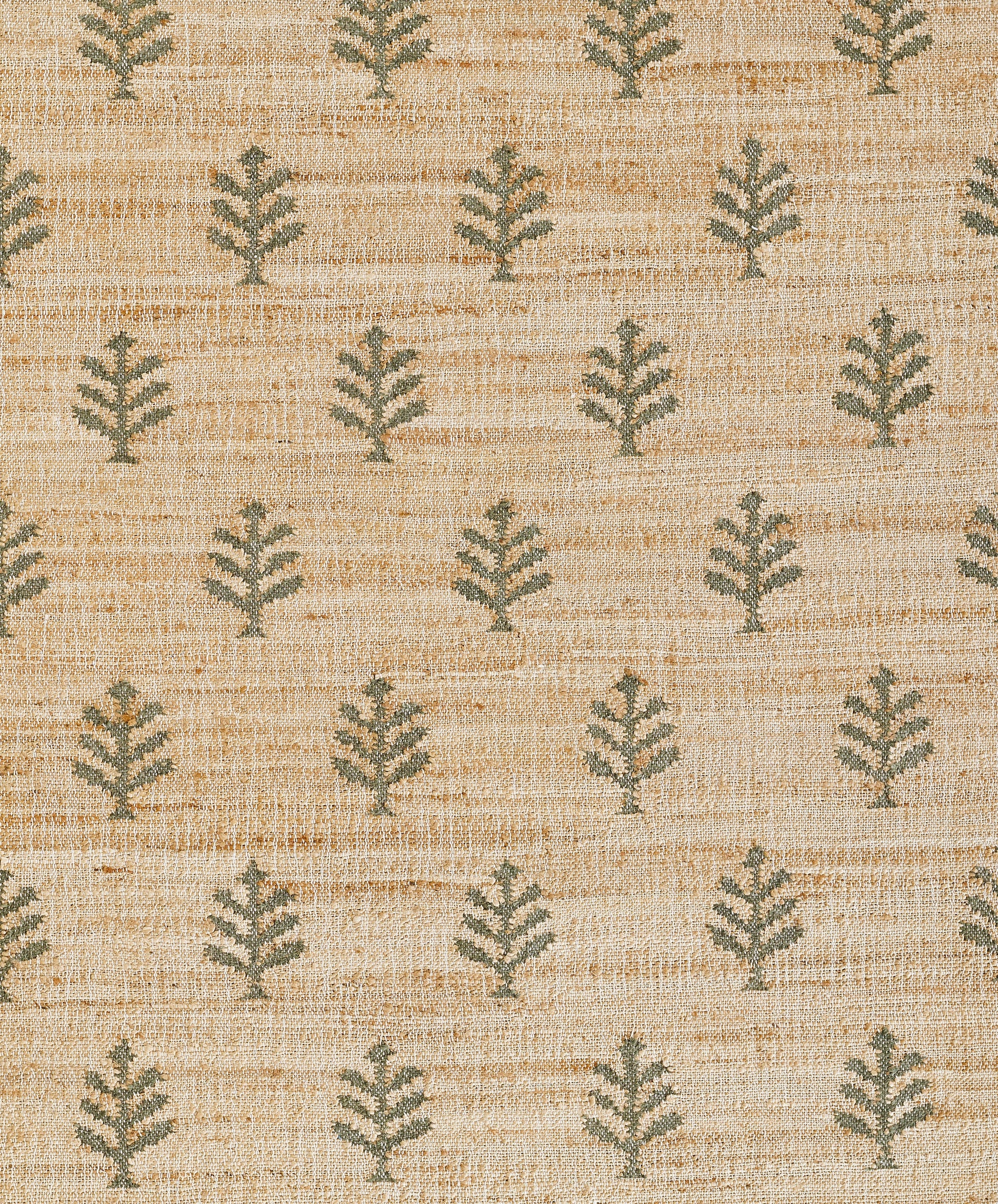 Natural beige woven rug with repeating green fern motifs on a textured background.