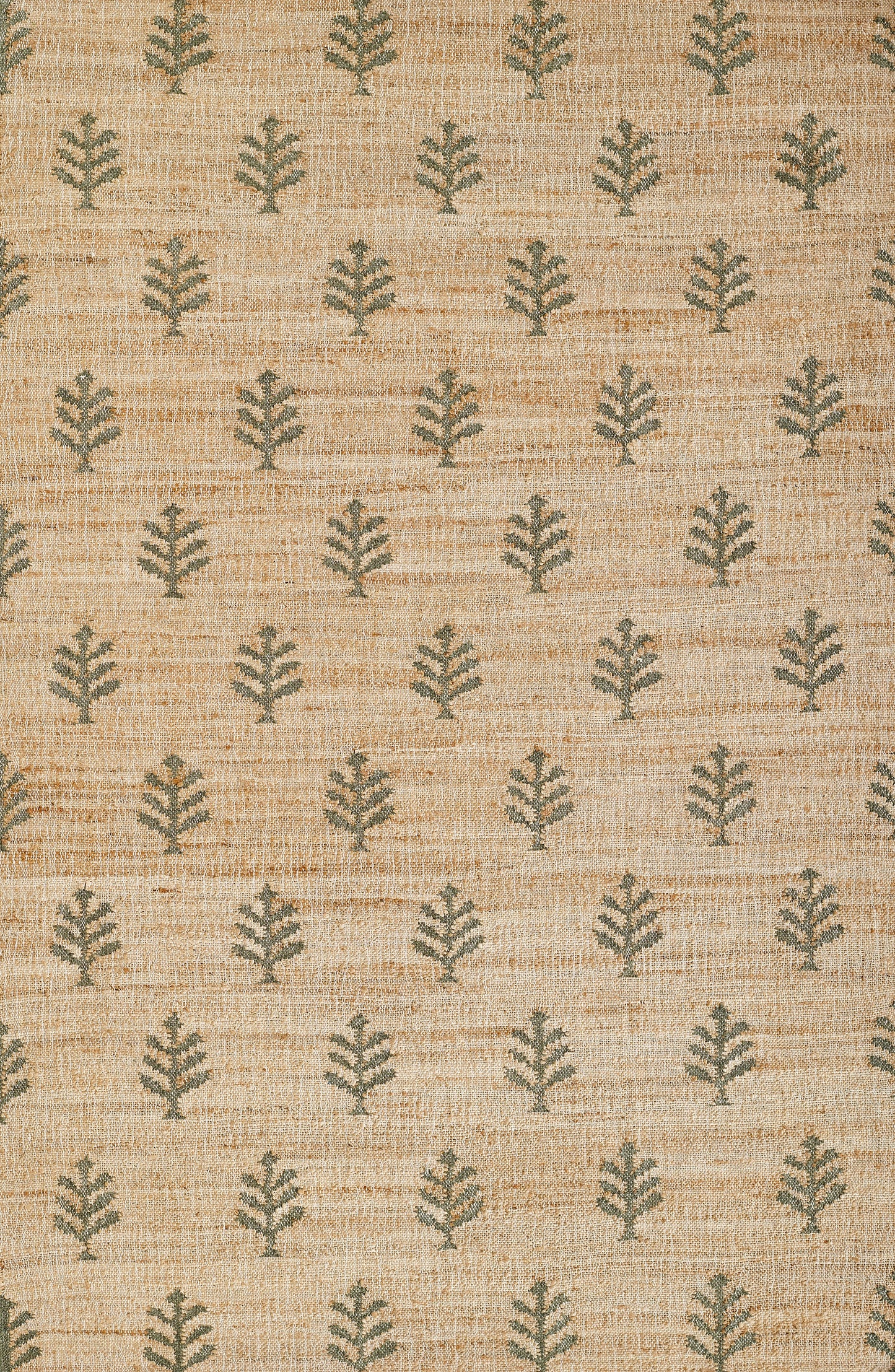 Natural beige jute rug with small green leaf motifs in repeating rows for a casual botanical look.