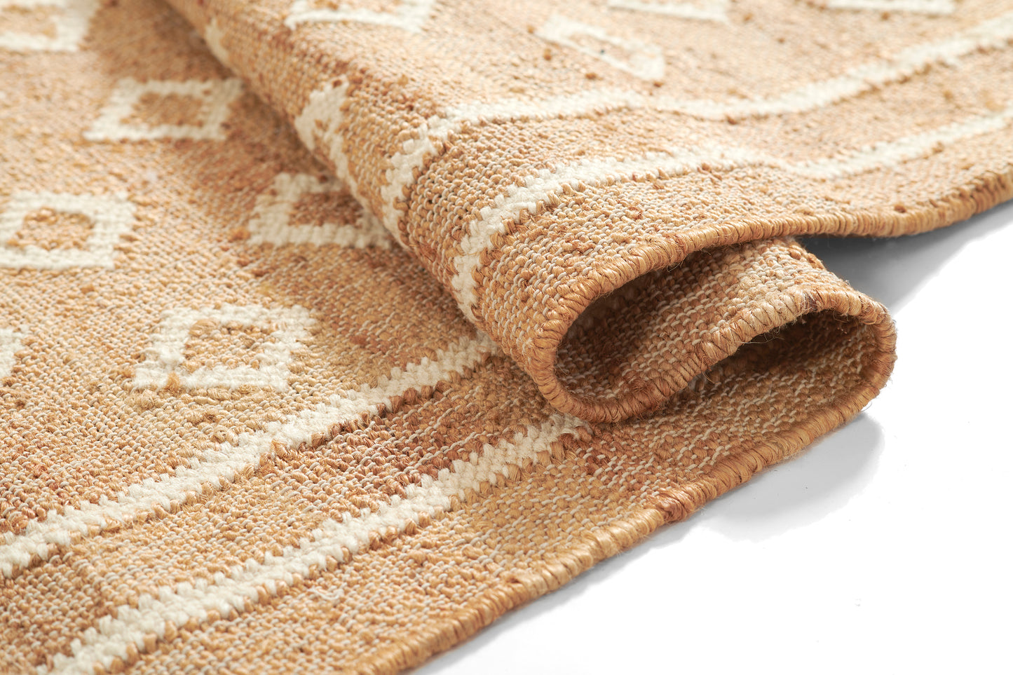 Beige natural woven rug with white diamond geometric pattern, rolled edge, rustic decor.