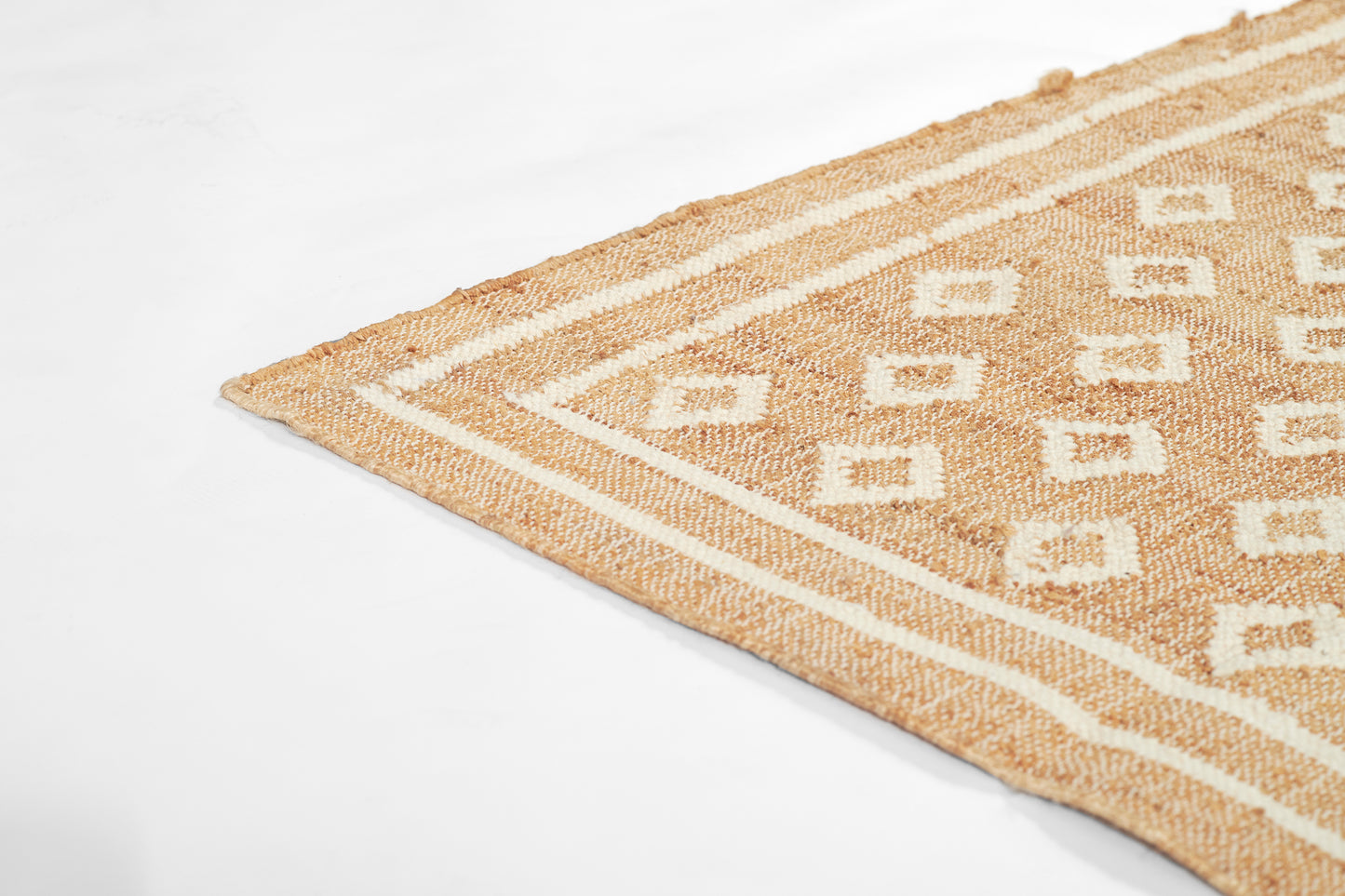 Beige natural-fiber woven rug with geometric diamond motif and striped border.
