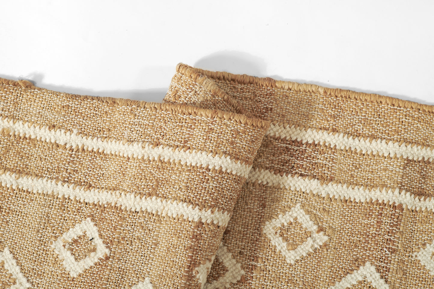 Natural jute rug with beige-brown and white geometric diamond pattern in a textured woven fabric, size 9' x 12'.