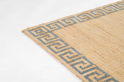 Beige jute rug with blue Greek-key border; natural woven texture.