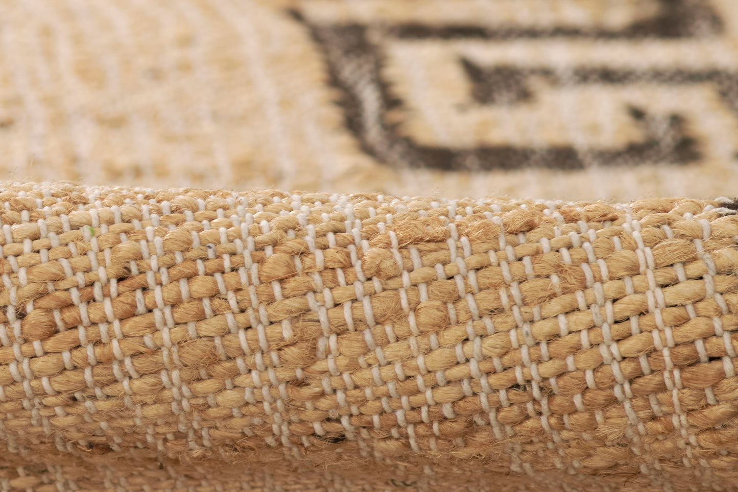 Natural beige-brown woven jute rug with textured stripes and rolled edge.