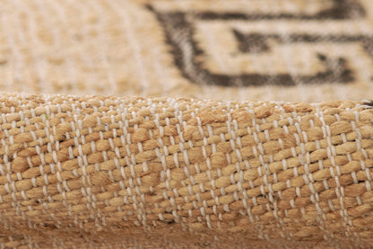 Natural beige jute rug close-up showing white woven stripes & chunky braided texture.