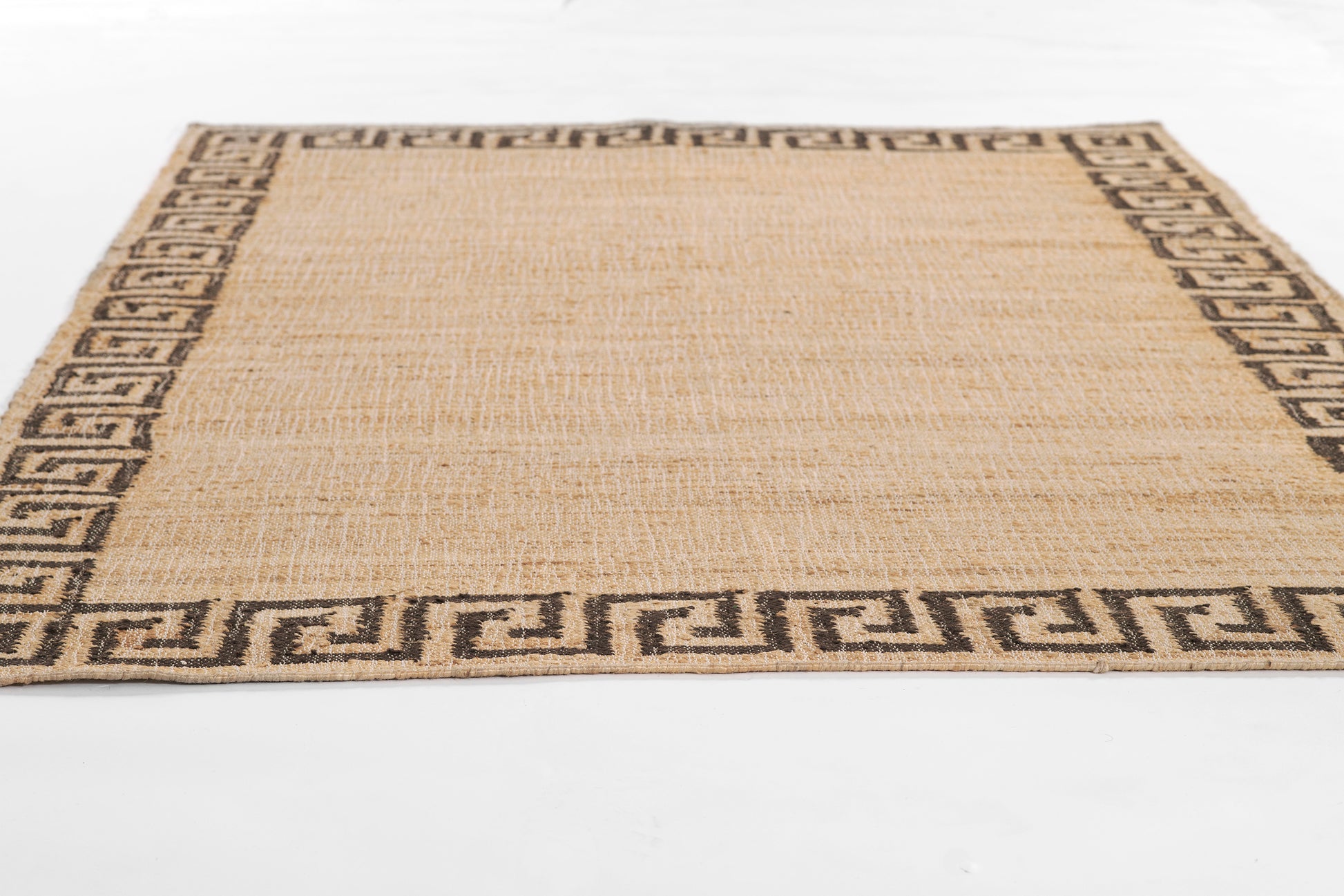 Natural beige jute rug with black Greek key border; rectangular, woven texture, low-pile.
