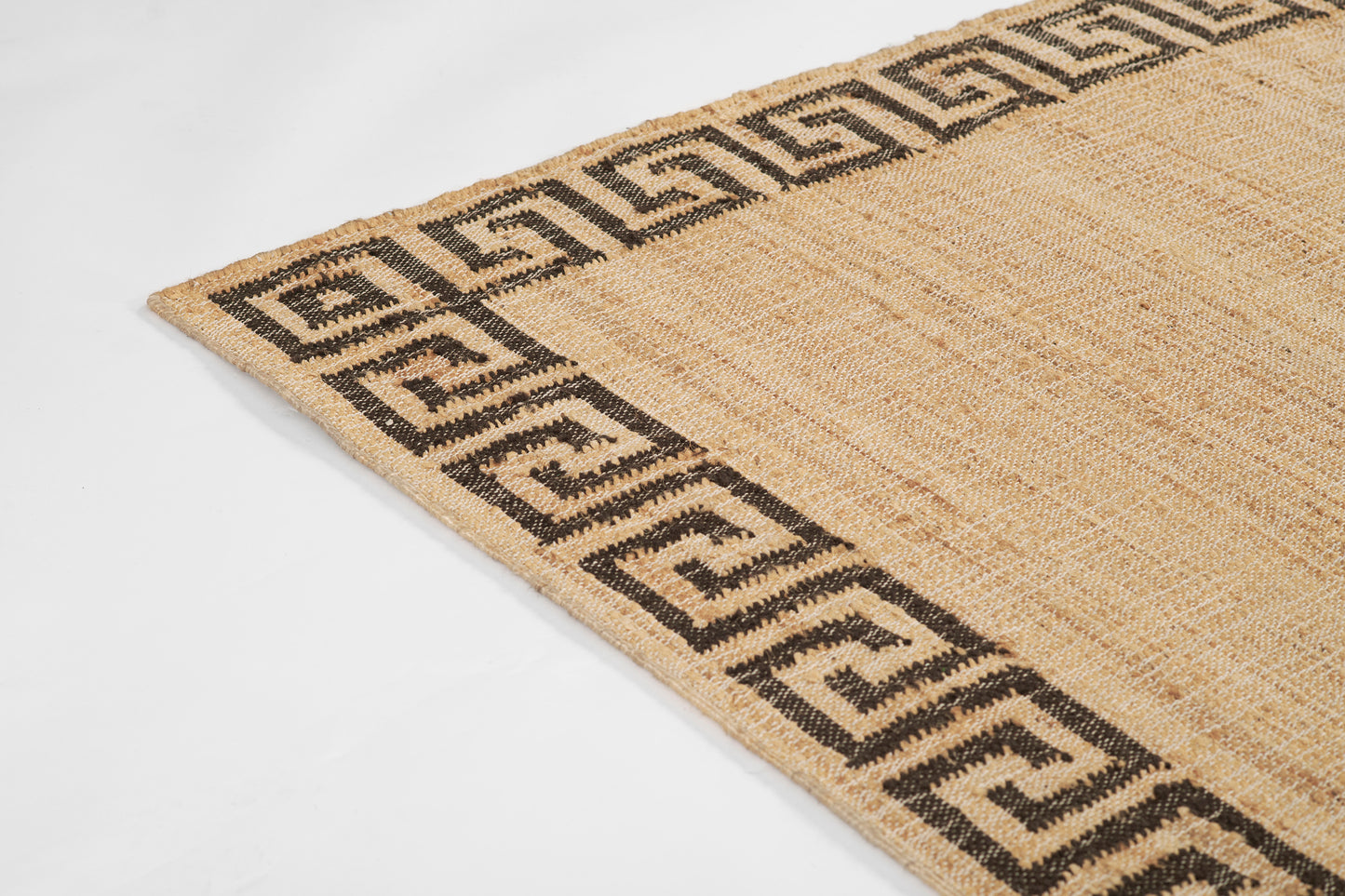 Natural beige jute rug with a bold black Greek key border; rectangular, chunky weave for rustic living spaces.