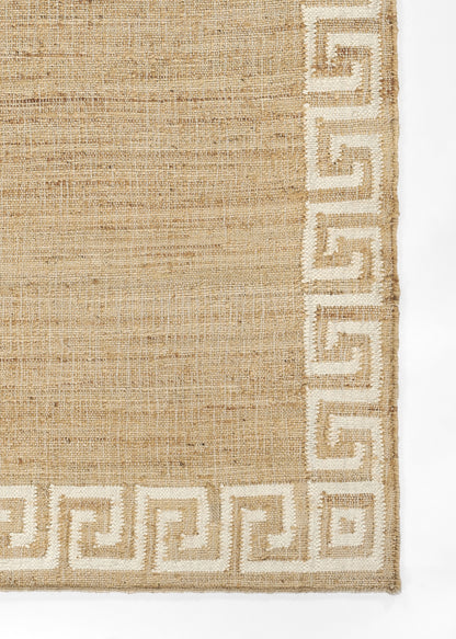 Natural beige jute rug with white Greek key border along edges; rectangular, casual coastal style.