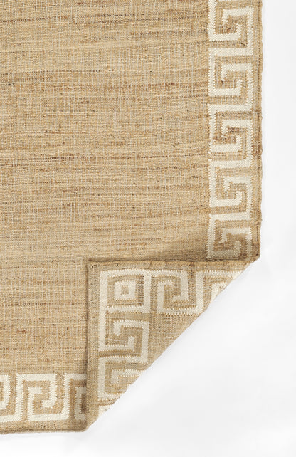 Beige woven rug with a light Greek key border, natural jute texture, and a folded corner.