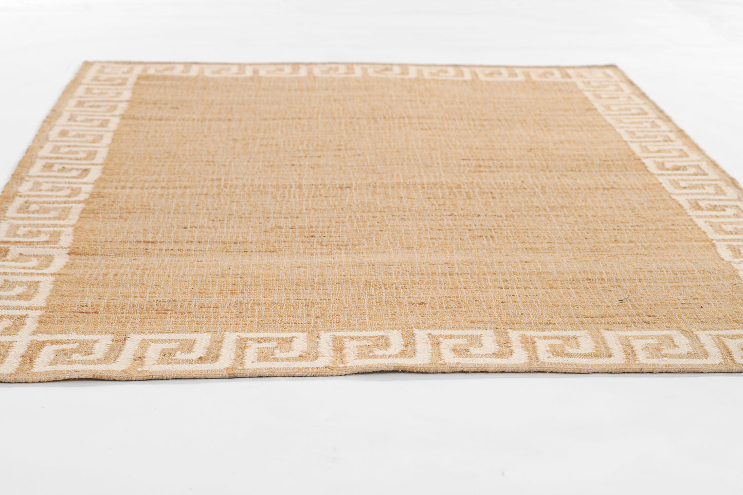Beige natural jute rug with cream Greek key border; rectangular, woven texture, casual coastal style.