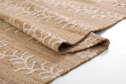 Beige woven area rug with cream vine stripe pattern and soft looped pile, folded edge.