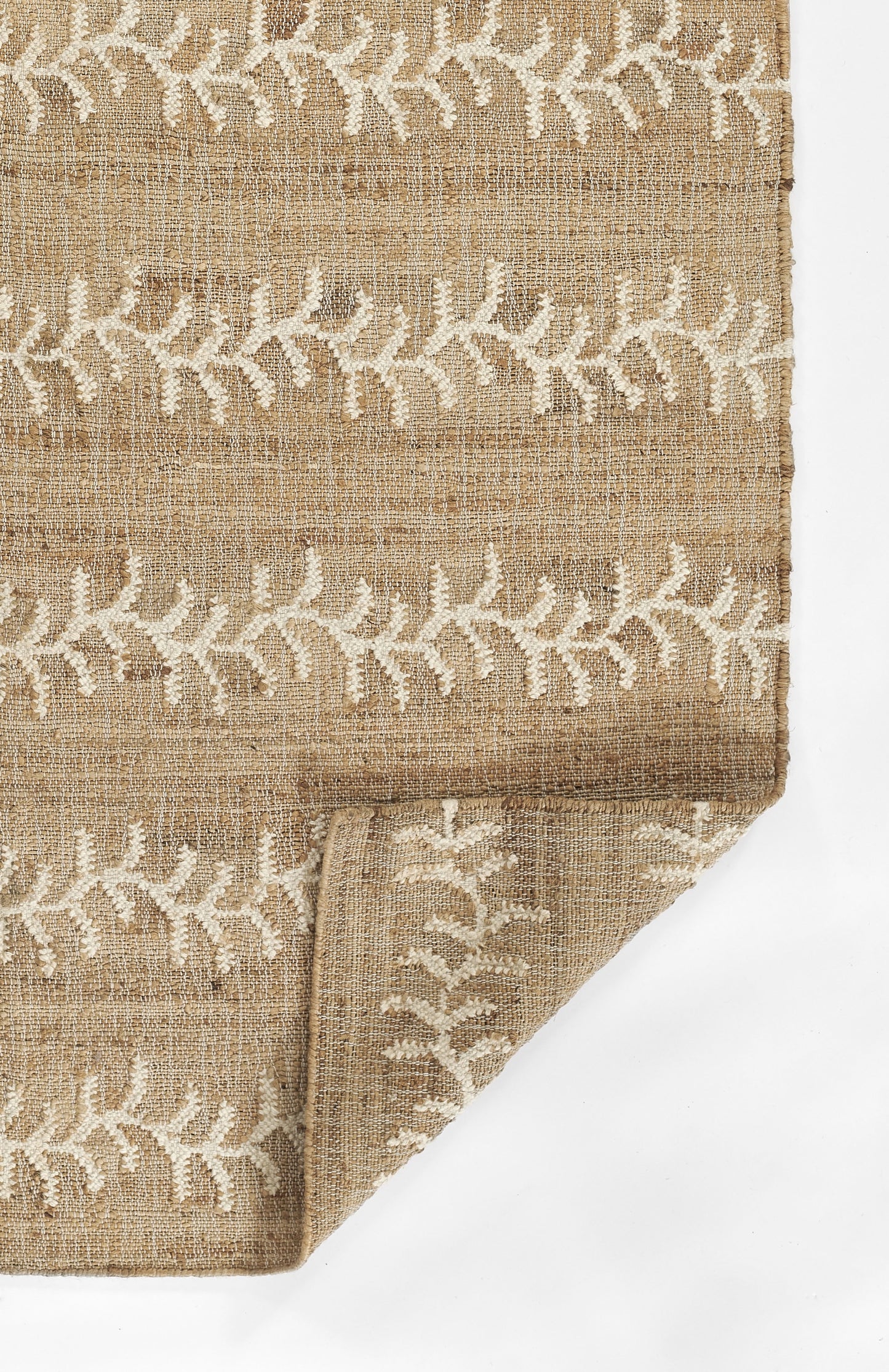 Natural jute rug with white embroidered ivy vine pattern in horizontal bands, rustic boho style.